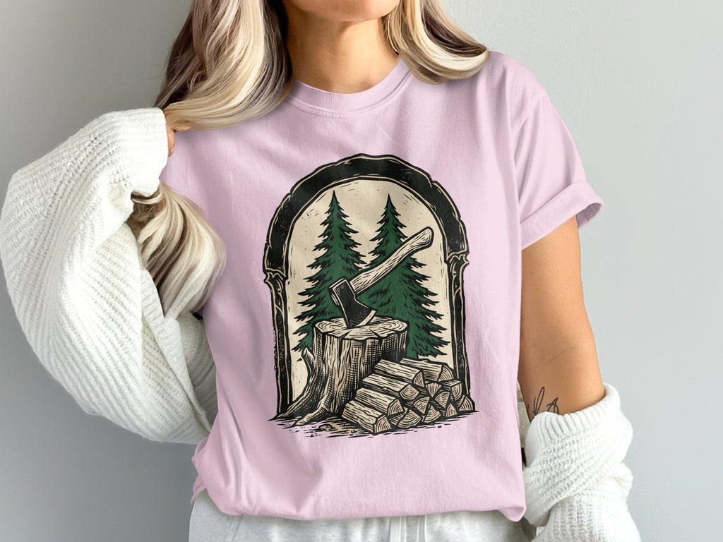 Pink t-shirt with a graphic of an ax in a tree stump and firewood.
