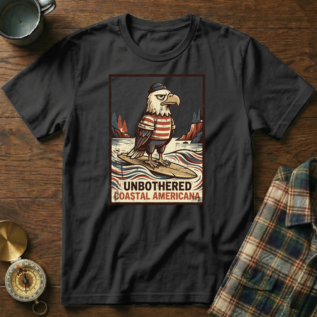 Eagle in striped shirt and hat on surfboard with text "UNBOTHERED COASTAL AMERICANA".