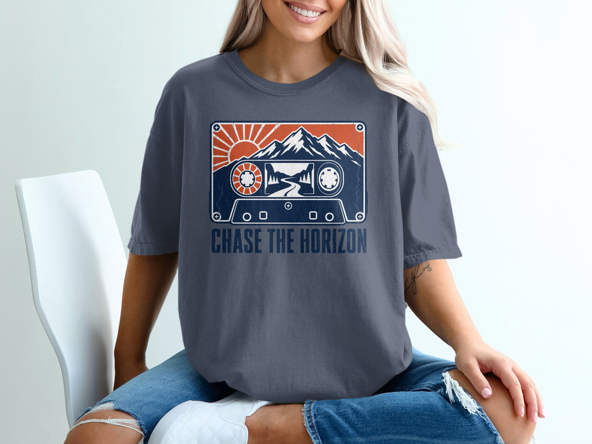 T-shirt with a vintage cassette tape graphic featuring mountains and sun, text reads "CHASE THE HORIZON".