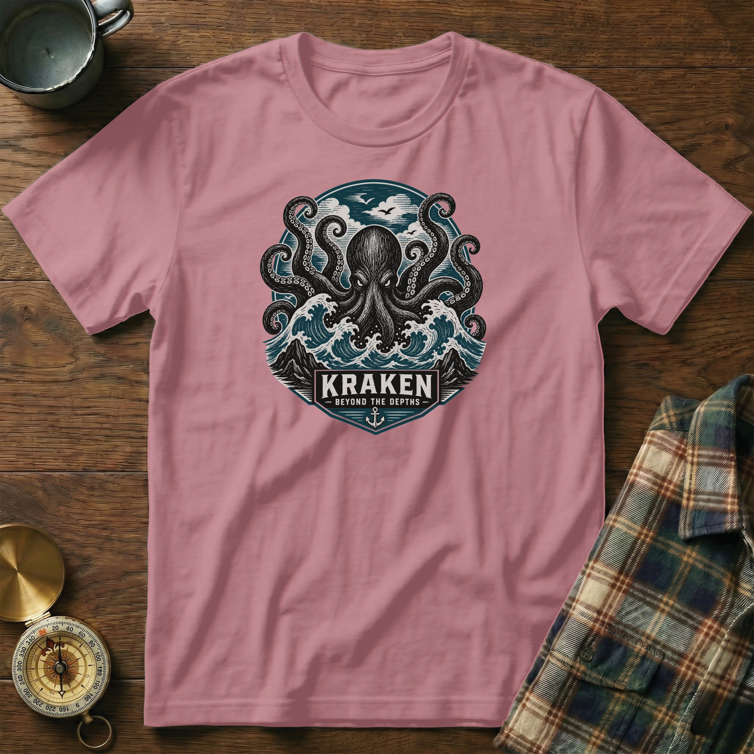 Pink t-shirt with kraken, waves, and text "KRAKEN BEYOND THE DEPTHS".
