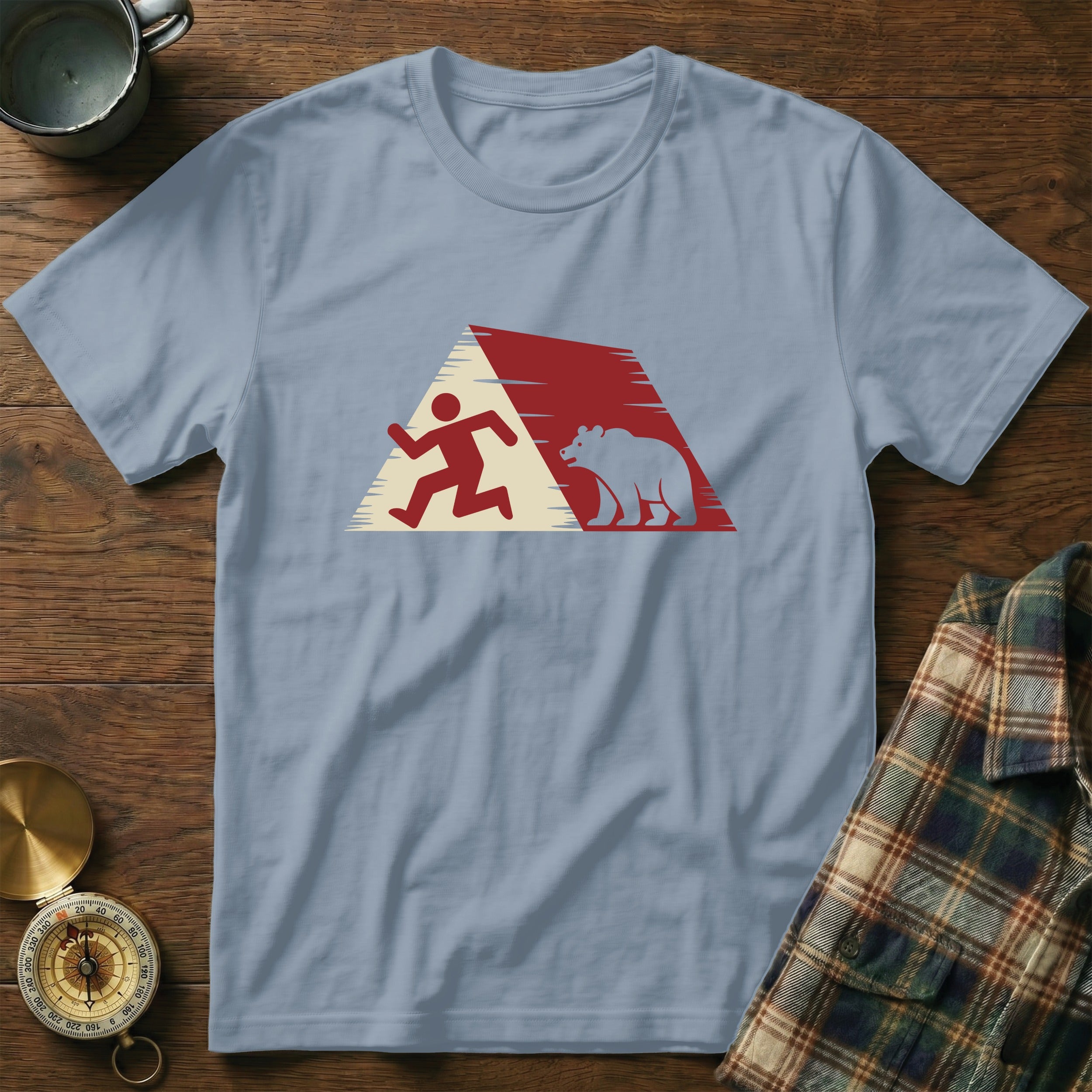 Light blue t-shirt with graphic of running person and bear inside a red and white triangle.