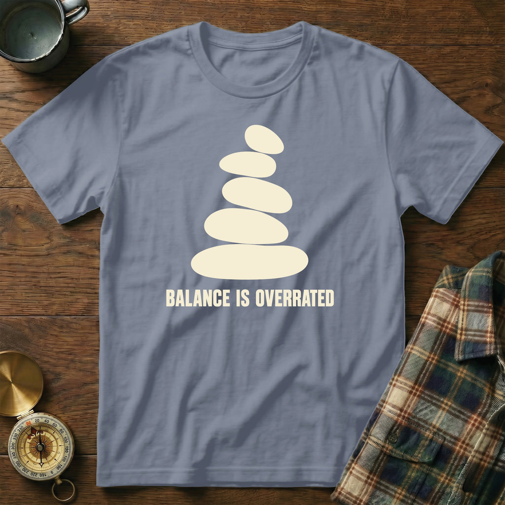Gray t-shirt with stacked stones graphic and "BALANCE IS OVERRATED" text.