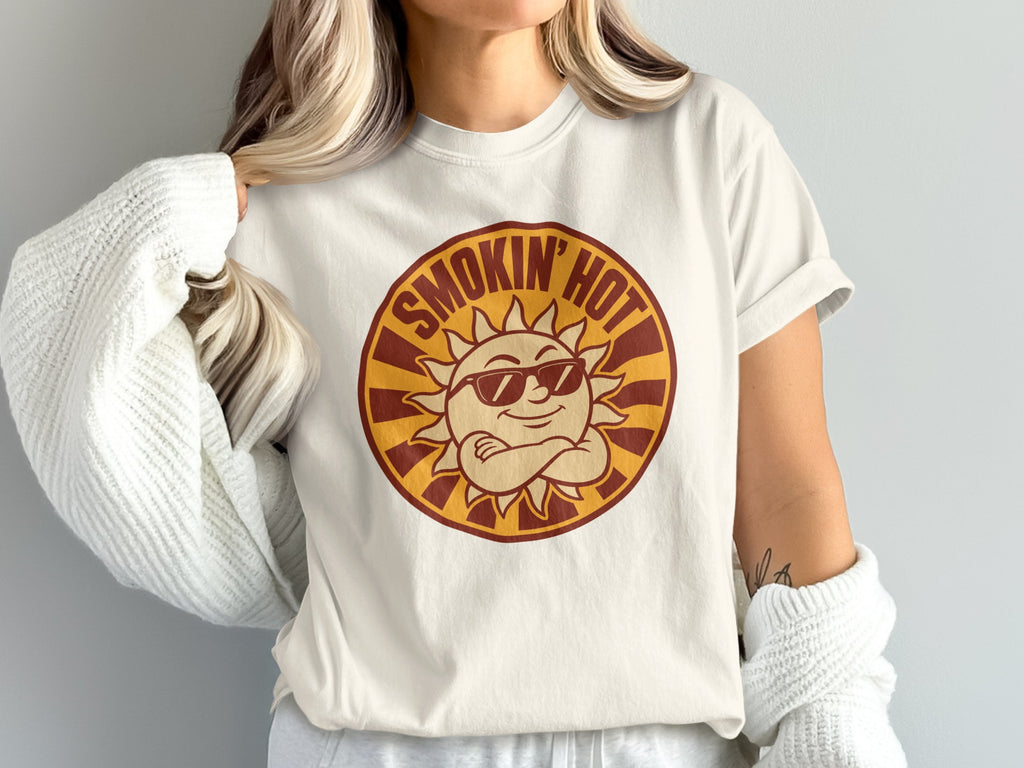 Off-white t-shirt with a circular graphic of a cartoon sun wearing sunglasses, text "SMOKIN' HOT".