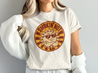 Off-white t-shirt with a circular graphic of a cartoon sun wearing sunglasses, text "SMOKIN' HOT".