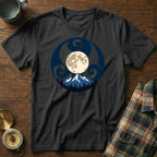 Black t-shirt with circular moon, mountains, and trees graphic.