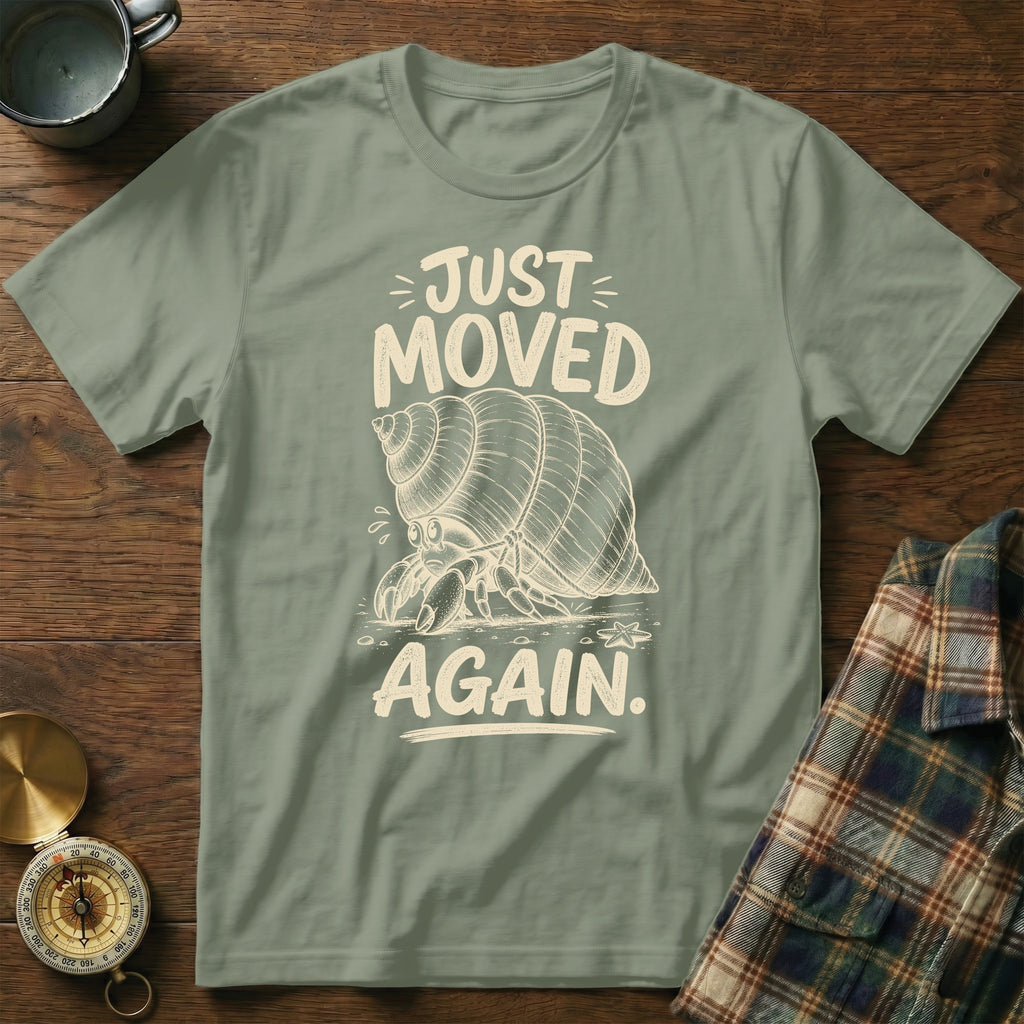 Green t-shirt with "JUST MOVED AGAIN" text and a hermit crab graphic.