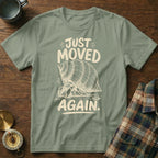 Green t-shirt with "JUST MOVED AGAIN" text and a hermit crab graphic.