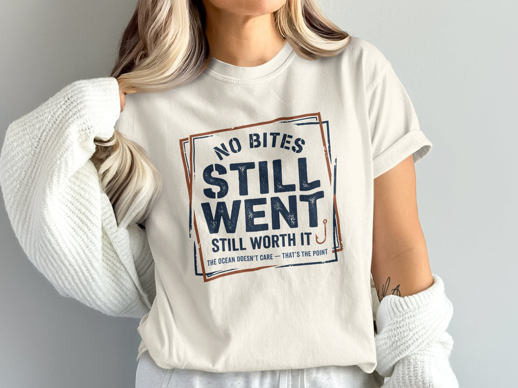 Cream t-shirt with "No Bites Still Went Still Worth It" text and fishing hook graphic.