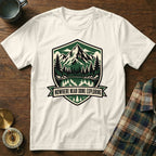 White t-shirt with mountain lake graphic and "Nowhere Near Done Exploring" text.