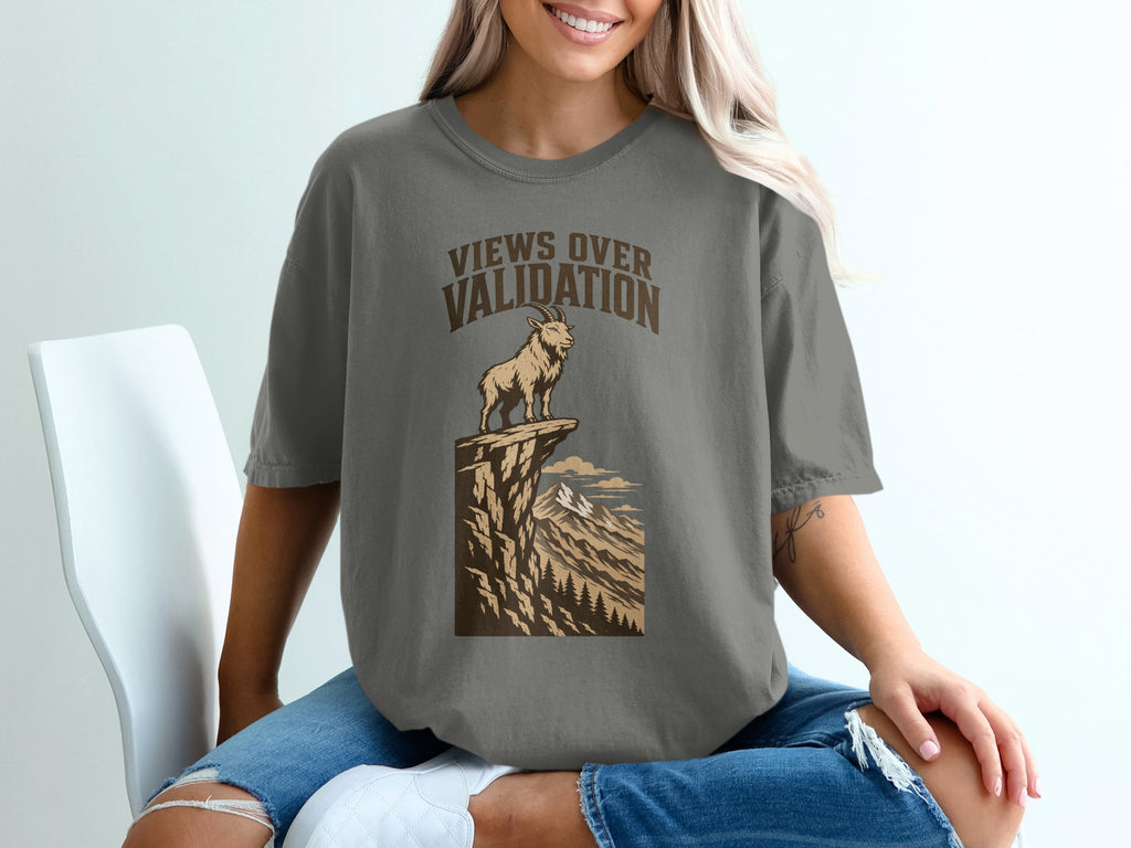 T-shirt graphic with text "VIEWS OVER VALIDATION" and mountain goat on cliff.