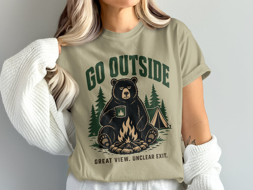 Bear with mug by campfire graphic on t-shirt, says "GO OUTSIDE GREAT VIEW. UNCLEAR EXIT."