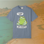 Blue T-shirt Funny T-shirt graphic featuring a large, grumpy toad holding a to-go coffee cup. The cartoon is captioned with the quotes: "IT'S MONDAY AGAIN? I WASN'T EVEN FINISHED WITH MY SATURDAY YET.