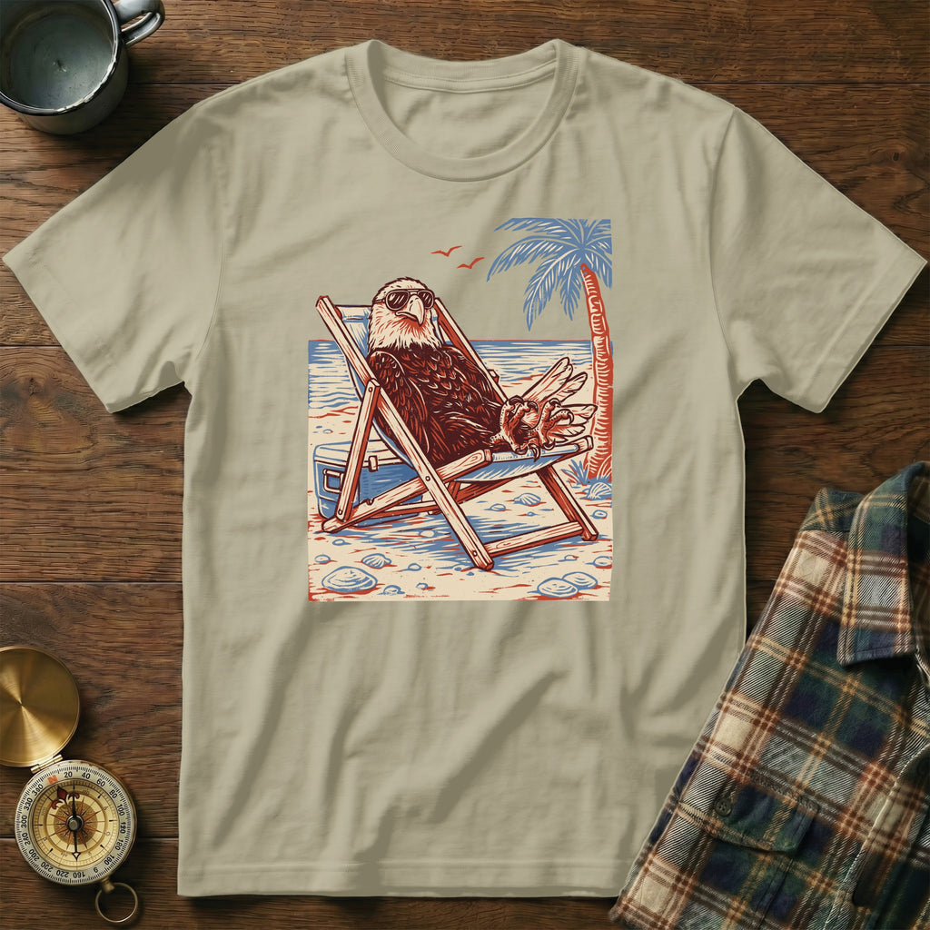 T-shirt with a print of an eagle in sunglasses relaxing on a beach chair.