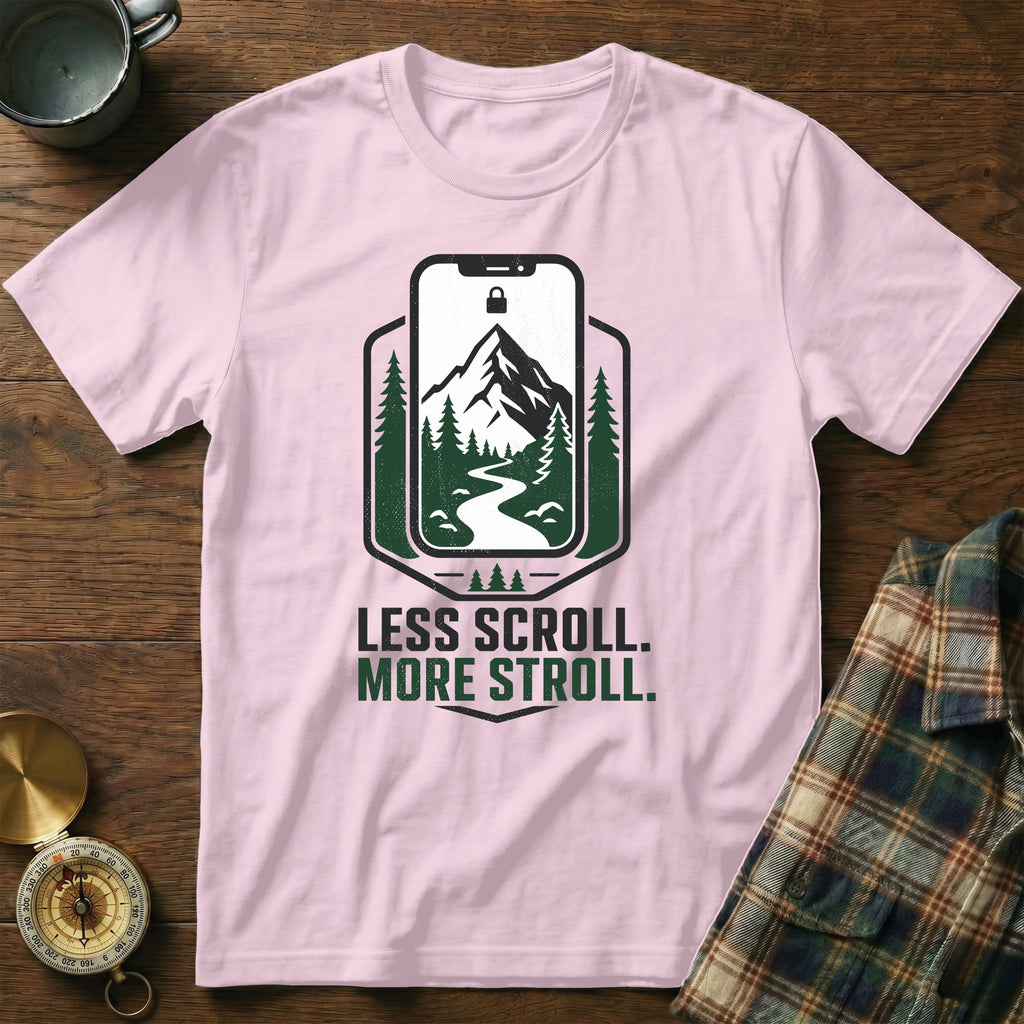 Pink t-shirt with "Less Scroll. More Stroll." text and mountain graphic.