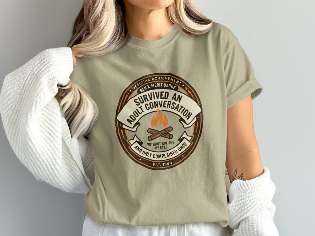 T-shirt featuring "Survived An Adult Conversation" Gen X merit badge design.