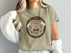 T-shirt featuring "Survived An Adult Conversation" Gen X merit badge design.