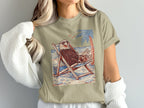 Eagle wearing sunglasses relaxing in a beach chair with palm tree and ocean.