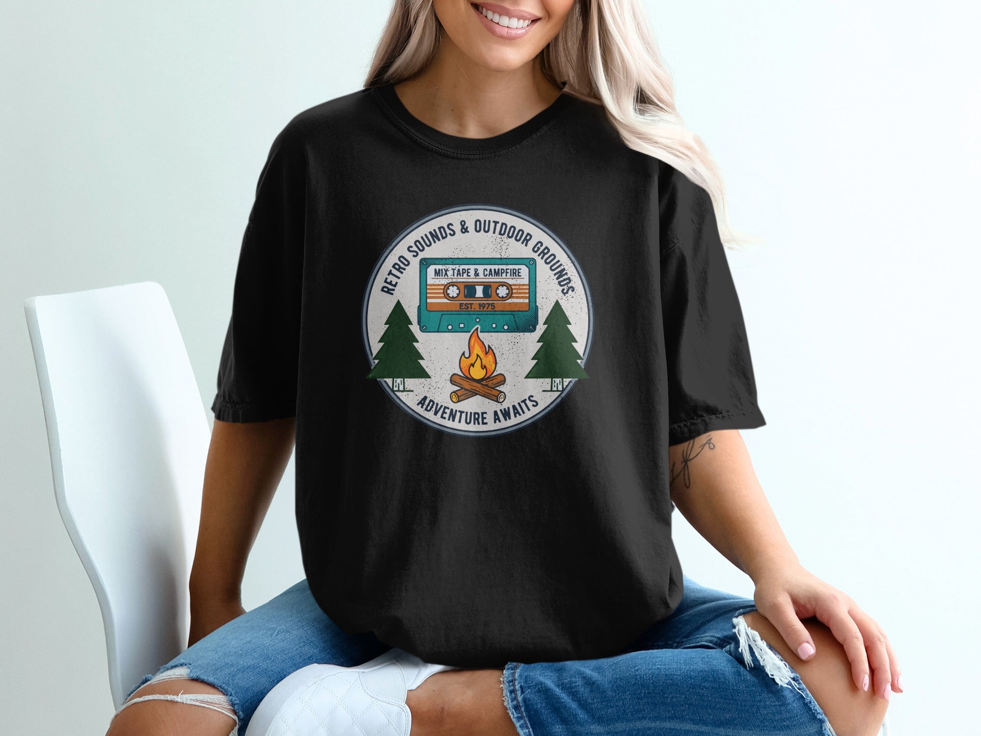 Black t-shirt with retro cassette tape, campfire, and pine trees graphic.