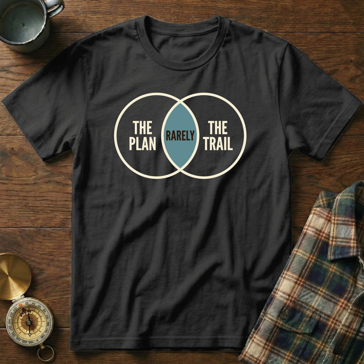 Black t-shirt with a Venn diagram showing "The Plan," "The Trail," and "Rarely" in the intersection.