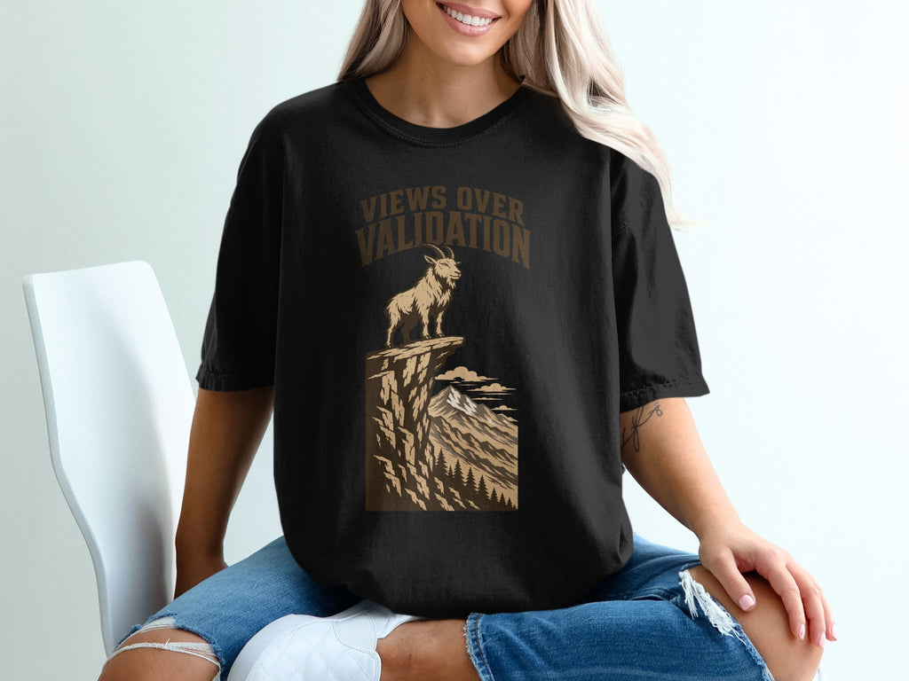 Black t-shirt with mountainous goat graphic and "Views Over Validation" text.