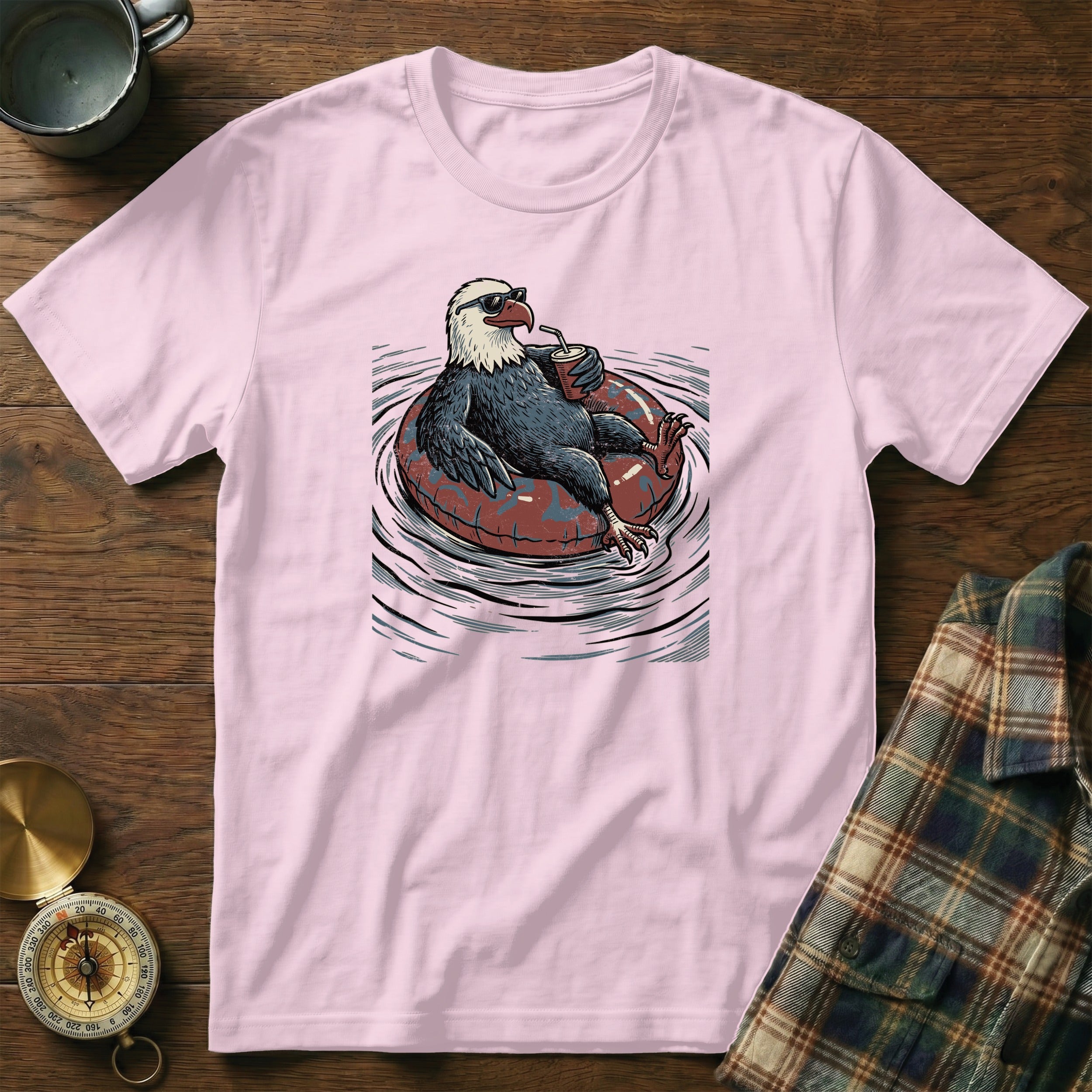 Eagle wearing sunglasses relaxes in an inner tube with a drink.