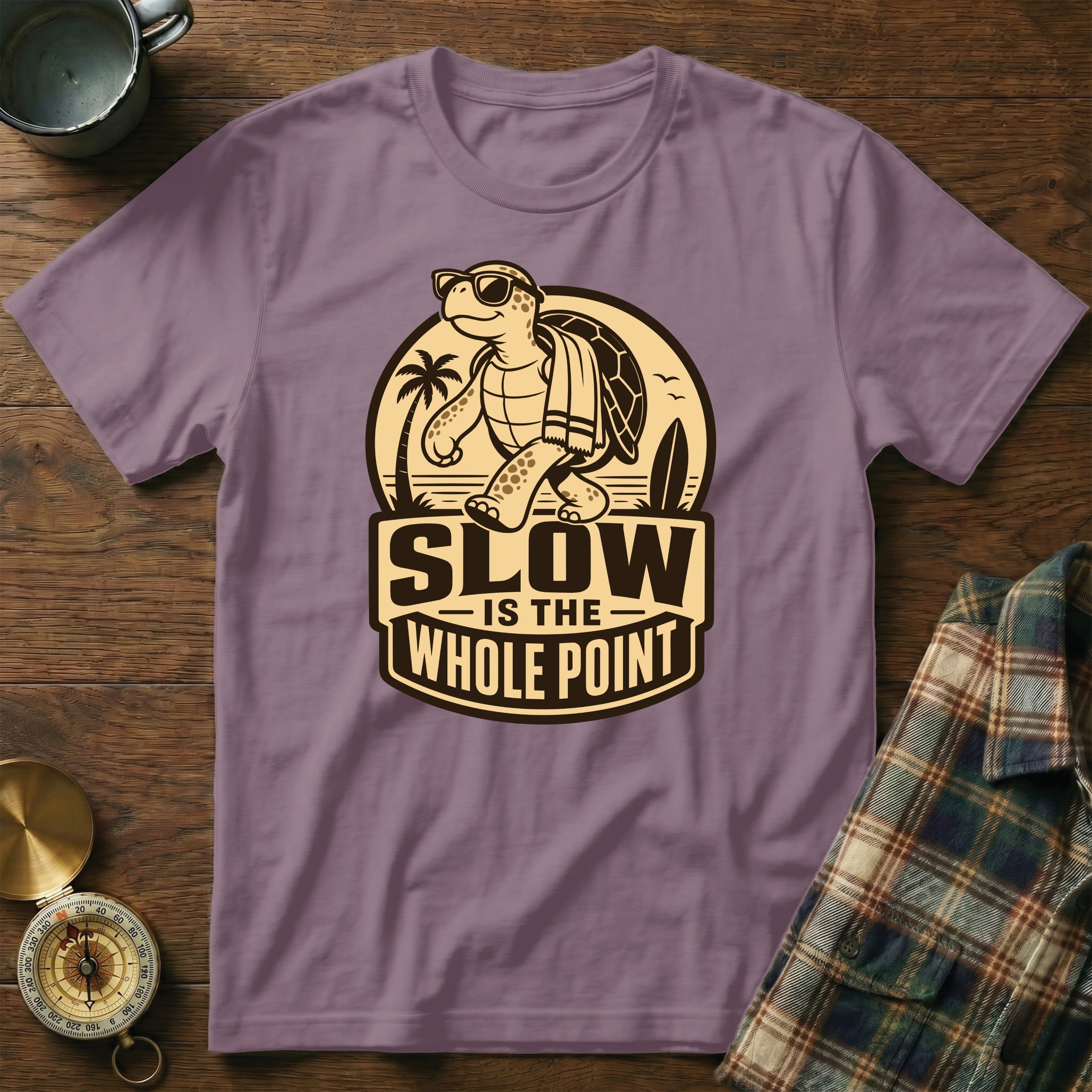 Purple t-shirt with graphic of a turtle wearing sunglasses and text "Slow is the Whole Point".