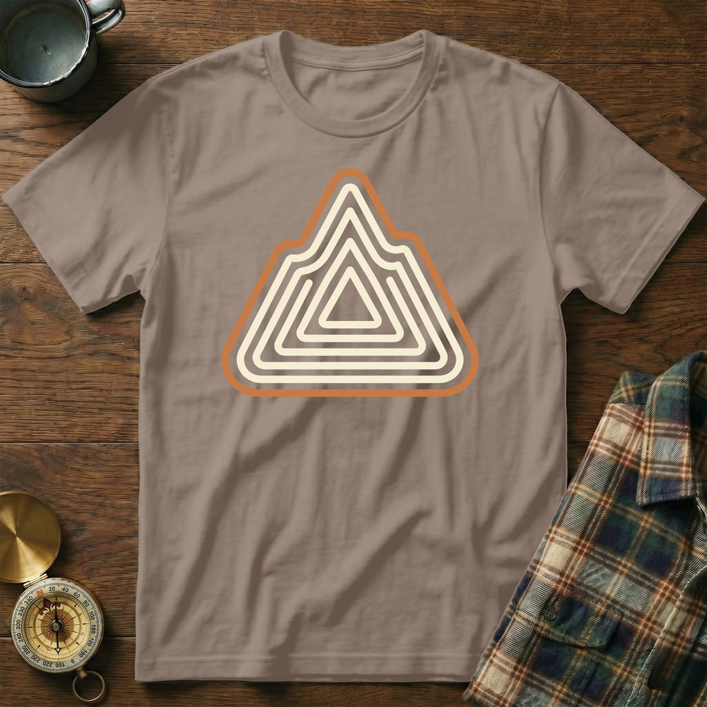 Brown t-shirt with abstract mountain range design in cream and orange.
