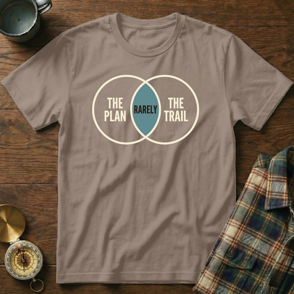 T-shirt with a Venn diagram graphic saying "The Plan", "The Trail", and "Rarely".