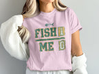 Pink t-shirt with "FISH 1 ME 0" text and fish skeleton graphic.