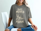 Gray t-shirt with "JUST MOVED AGAIN." and a hermit crab graphic.