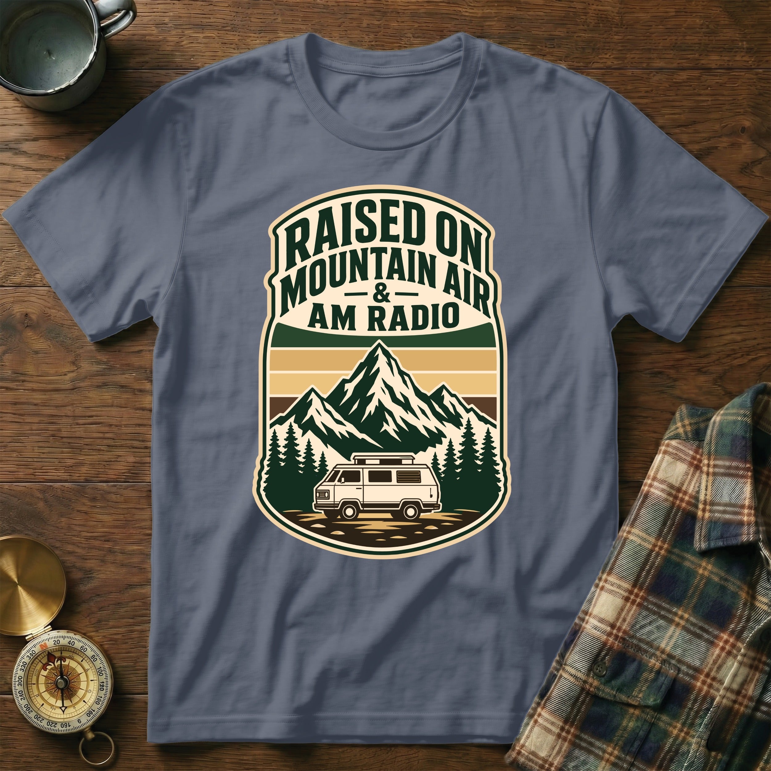 Grey t-shirt with "Raised on Mountain Air & AM Radio" graphic featuring mountains, trees, and a van.