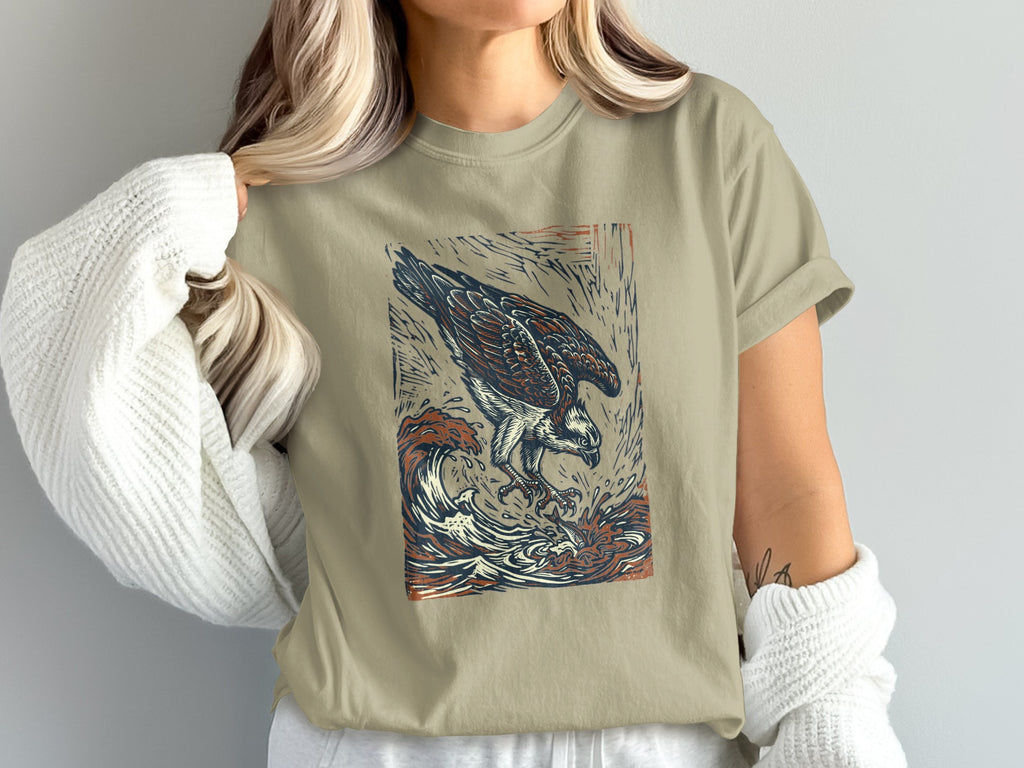 T-shirt with a graphic of an osprey diving into waves.