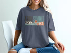 T-shirt with graphic text "From Summit to Sea" and mountain-ocean scene.