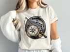 T-shirt with vintage compass, fishing rod, and leaping trout design.