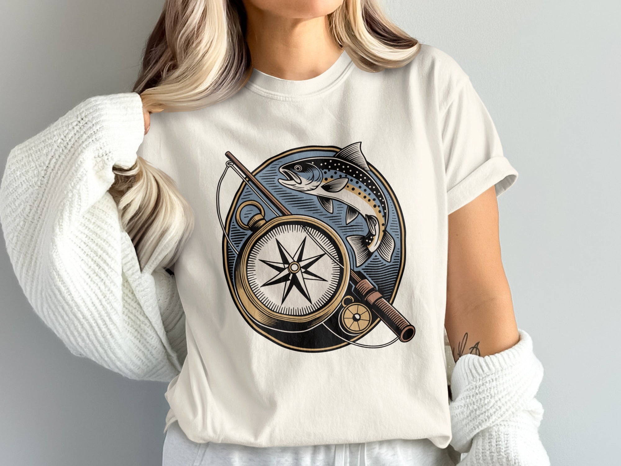 T-shirt with vintage compass, fishing rod, and leaping trout design.