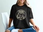 Black t-shirt with a graphic of a turtle giving a thumbs up next to a sandcastle.