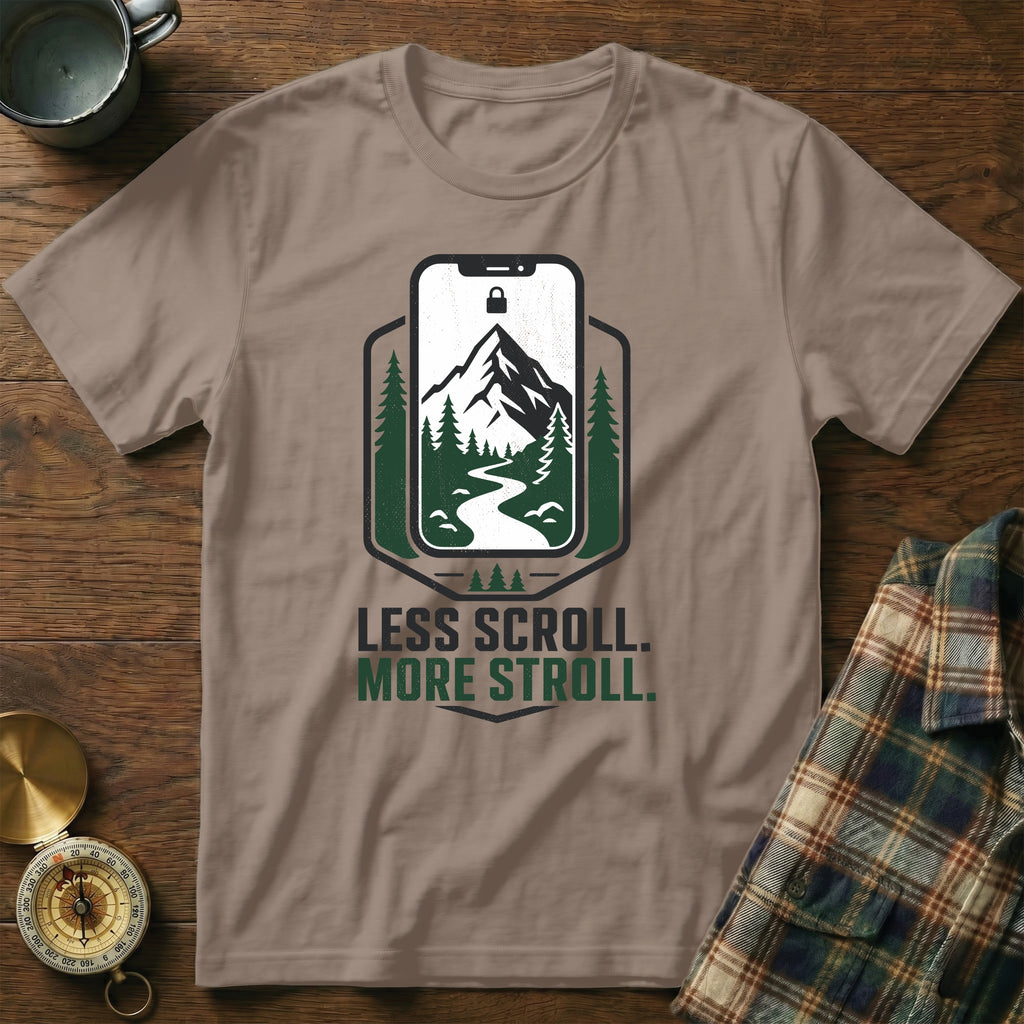 T-shirt with "Less Scroll. More Stroll." text and mountain landscape graphic.