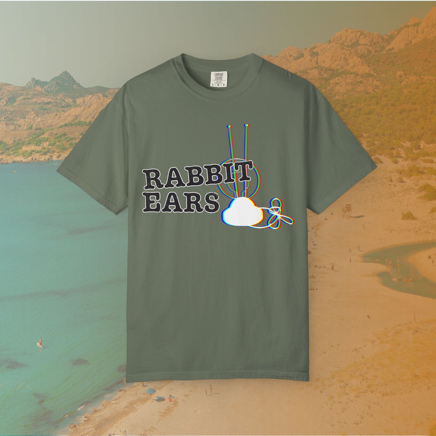 green t-shirt distressed EDM music festival text "RABBIT EARS" next to a graphic of a vintage TV antenna and cloud shape with a red, green, and blue (RGB) chromatic aberration/glitch effect, with an RGB shift design