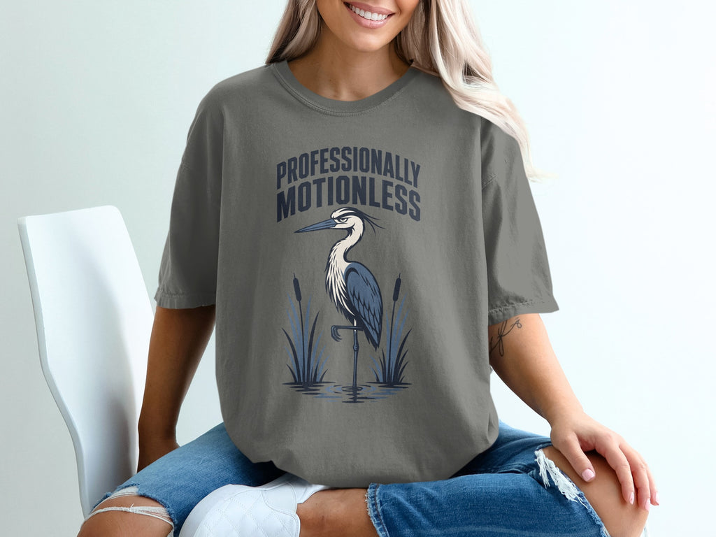 Gray t-shirt with "PROFESSIONALLY MOTIONLESS" and heron graphic.