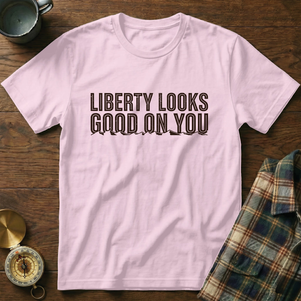 Pink t-shirt with "Liberty Looks Good On You" text and mountain graphic.