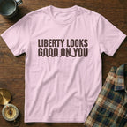 Pink t-shirt with "Liberty Looks Good On You" text and mountain graphic.