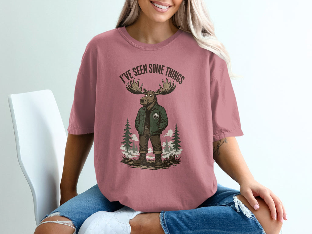 Graphic of moose with text "I'VE SEEN SOME THINGS" on rose shirt.