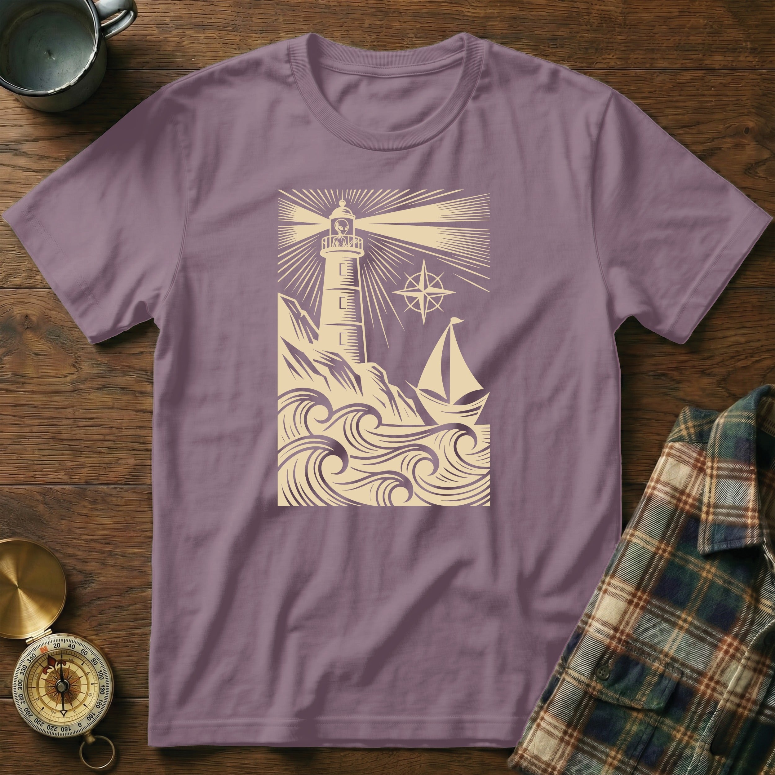 T-shirt with a vintage lighthouse and sailboat design.