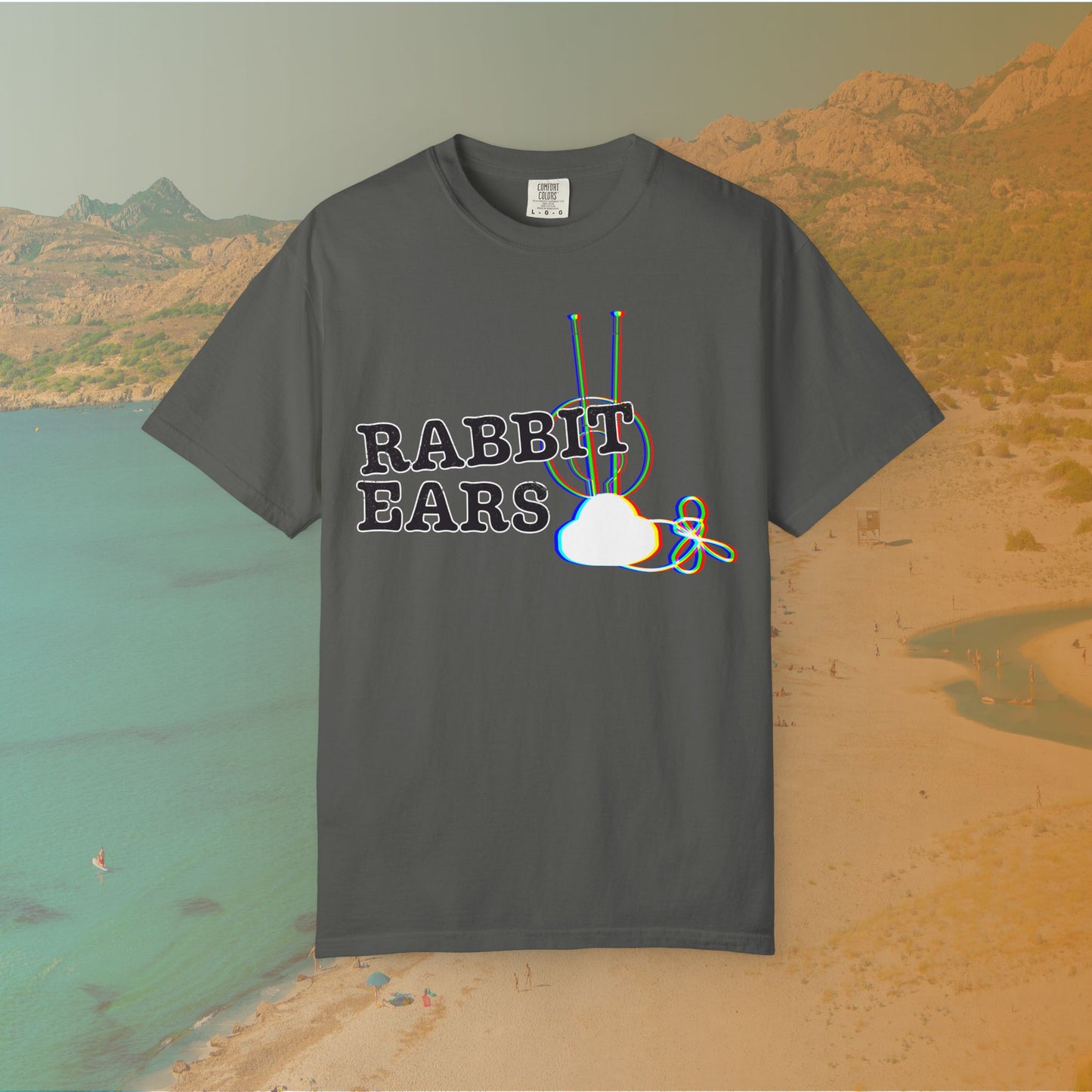 grey t-shirt distressed EDM music festival text "RABBIT EARS" next to a graphic of a vintage TV antenna and cloud shape with a red, green, and blue (RGB) chromatic aberration/glitch effect, with an RGB shift design