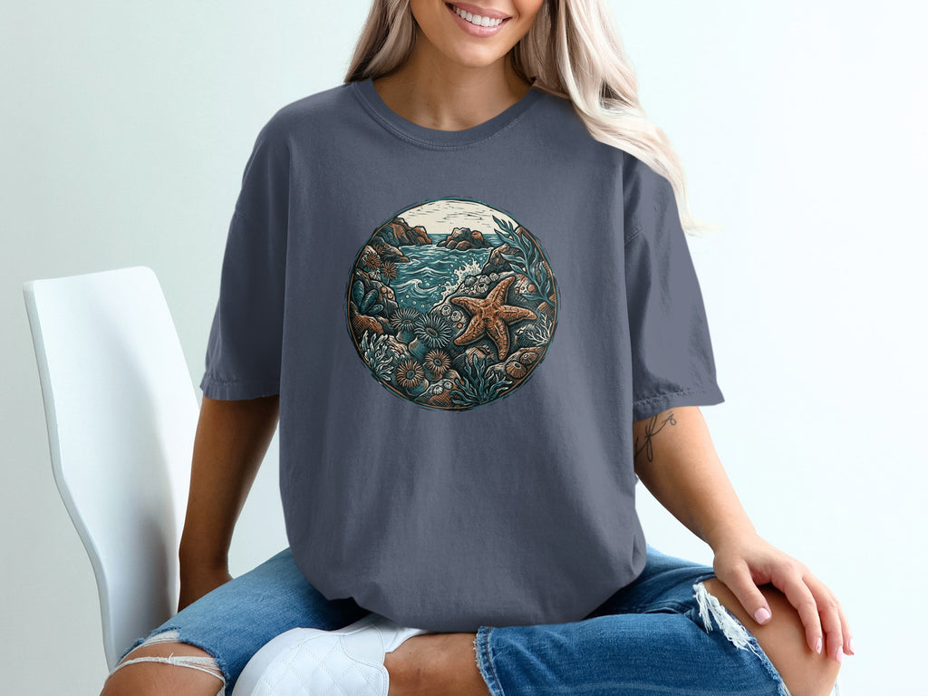 Graphic t-shirt with circular ocean scene featuring starfish and coral.