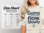 A woman wears a cream t-shirt with a size chart graphic displayed on the left side.