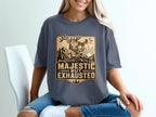 Deer graphic with text "Majestic But Exhausted" on a dark gray t-shirt.