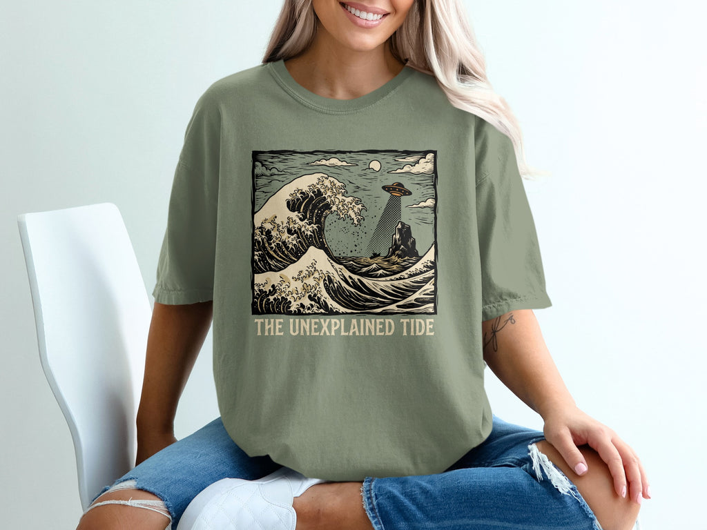 UFO abducting a person from a rock during a large wave, with text "THE UNEXPLAINED TIDE".