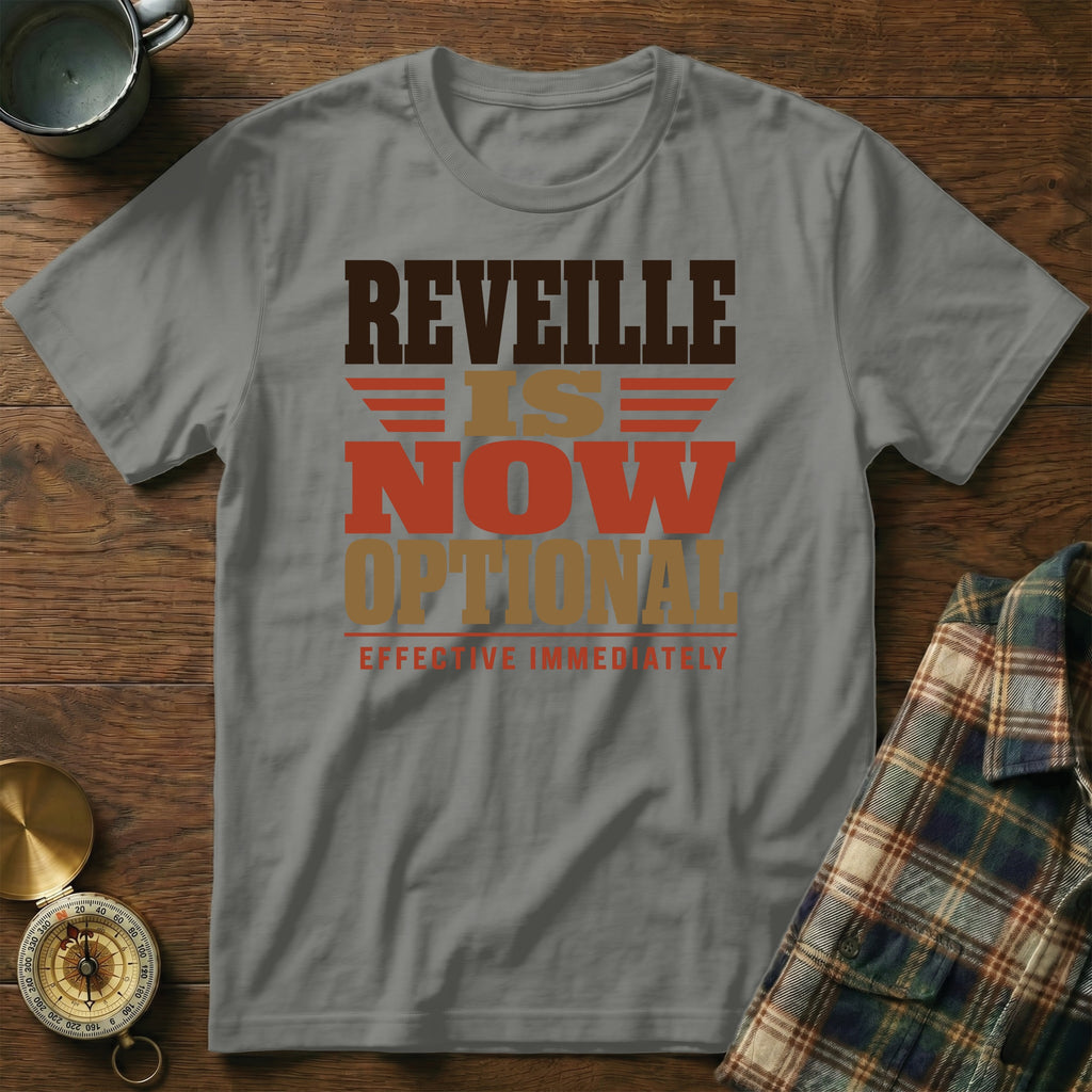 A grey t-shirt featuring distressed text that reads "REVEILLE IS NOW OPTIONAL EFFECTIVE IMMEDIATELY".