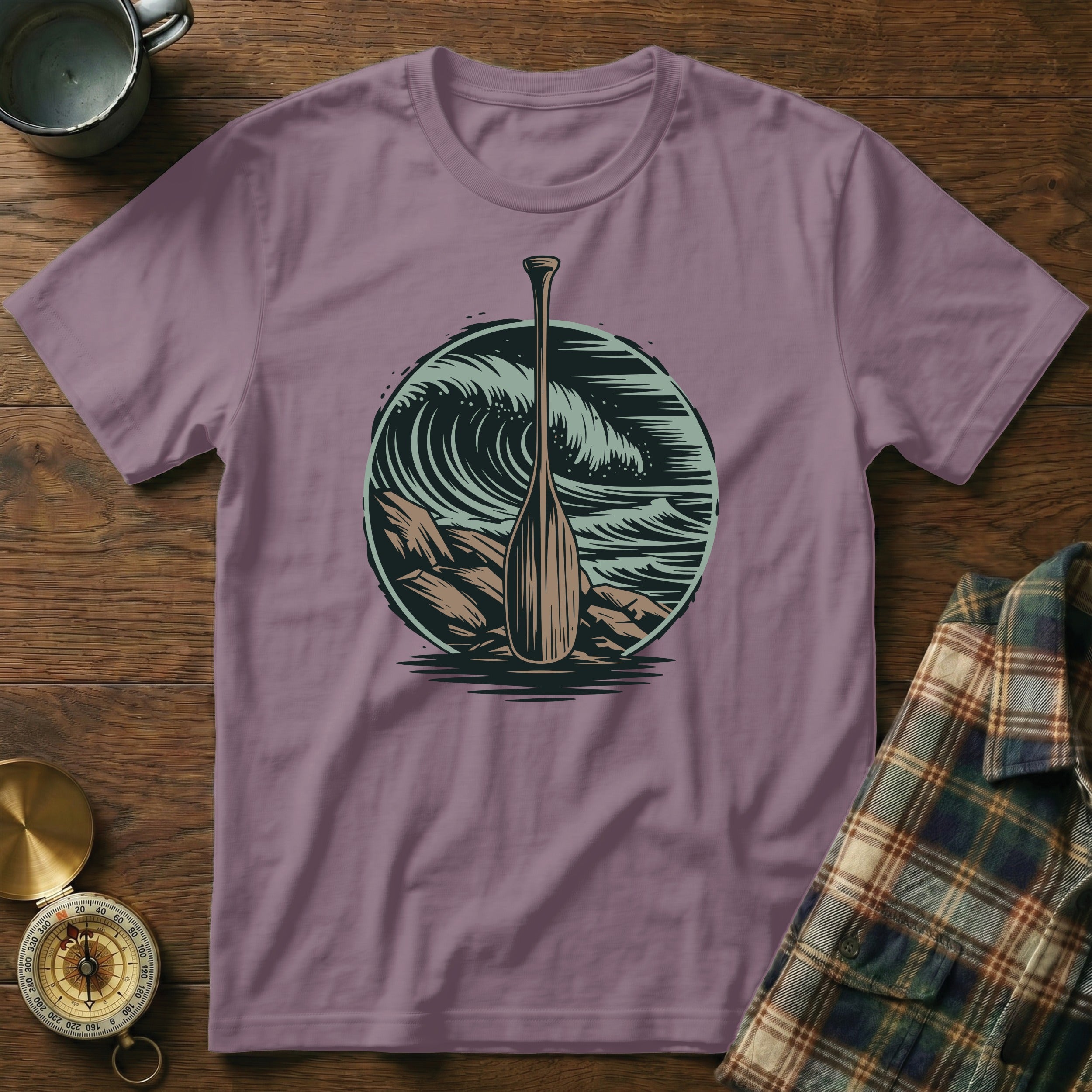 Purple t-shirt with a graphic of a canoe paddle against a large wave.